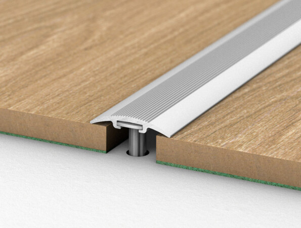 Aluminium transition profile connecting two laminate flooring sections.