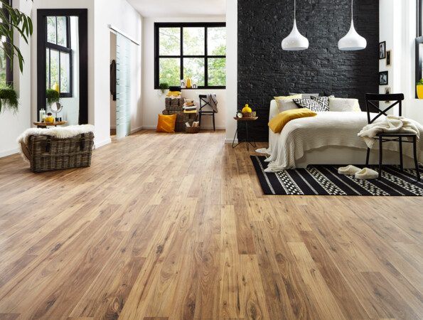 Elegant room with laminate flooring, a cosy bed, and stylish decor.