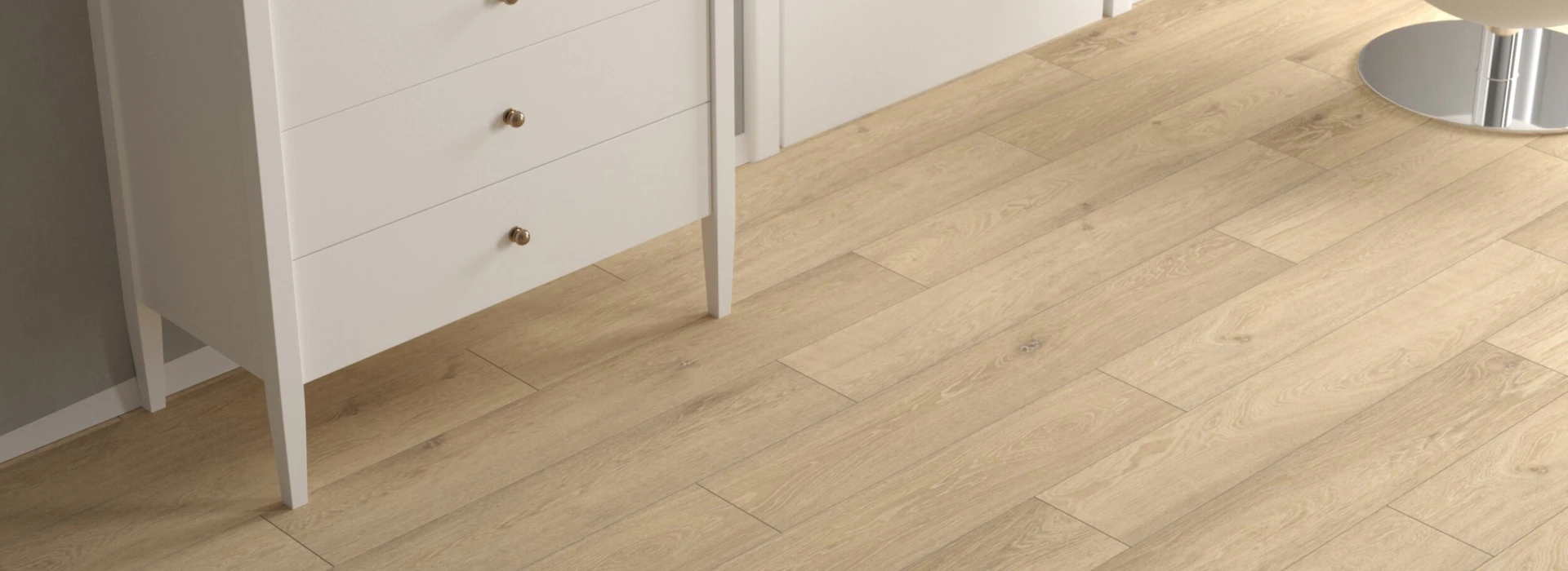 Moderner Raum mit hellem Laminatboden, weißer Kommode und Stuhl.