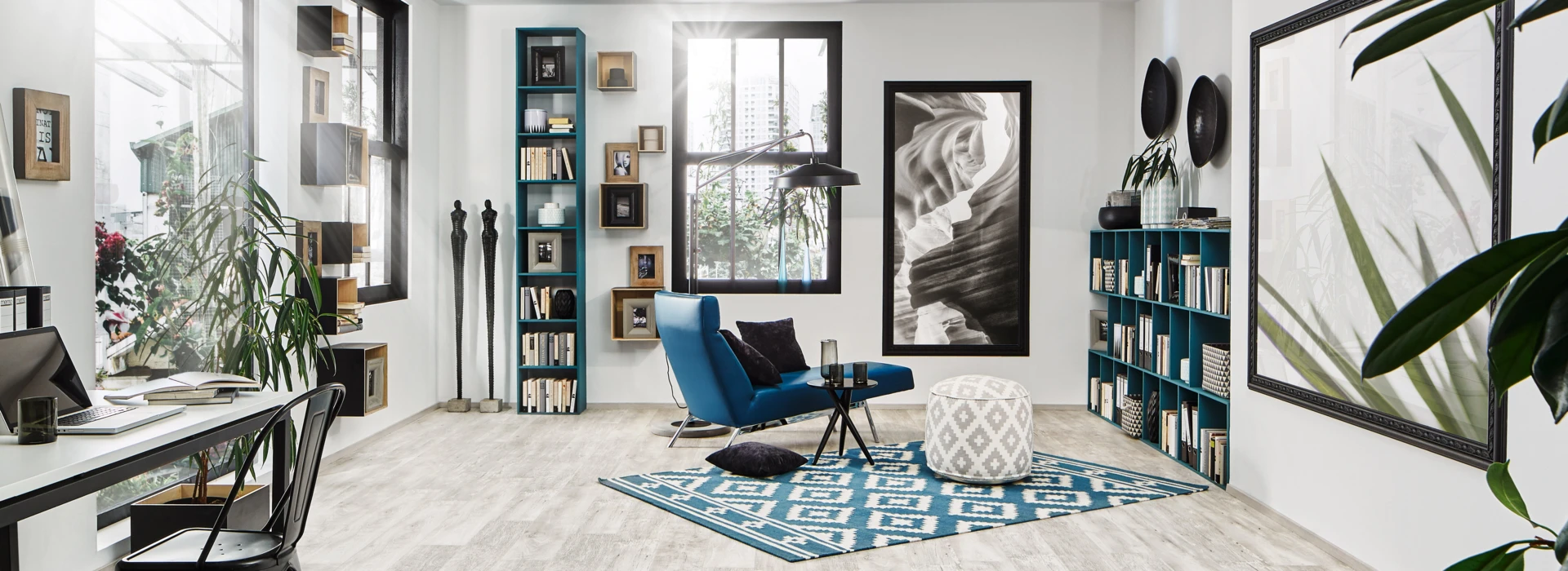 Bright room with stylish laminate flooring, featuring a desk, bookshelves, and a blue chair on a geometric rug.