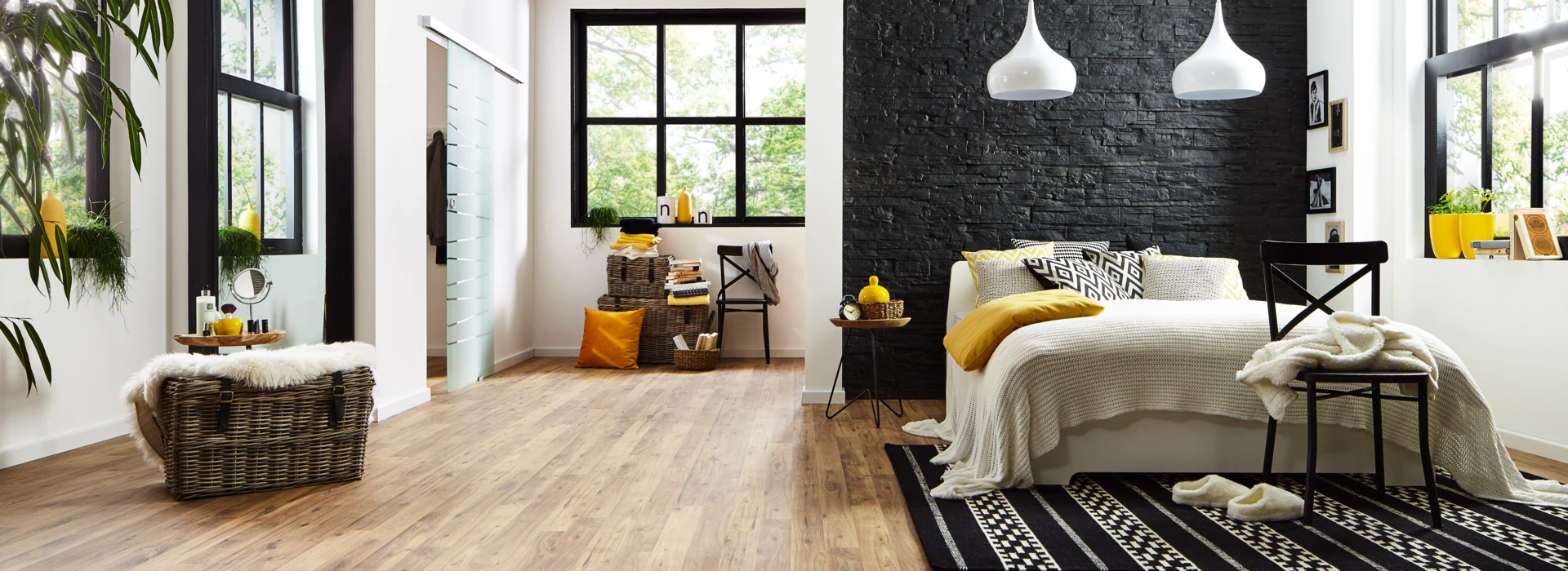 Elegant room with laminate flooring, a cosy bed, and stylish decor.
