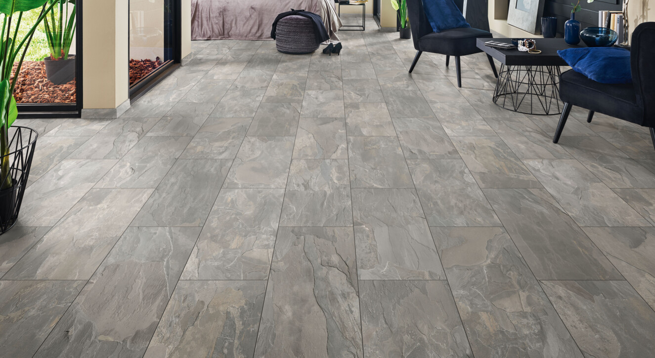 Bedroom with grey laminate flooring from the series 'Elementpro', large windows, and stylish decor.