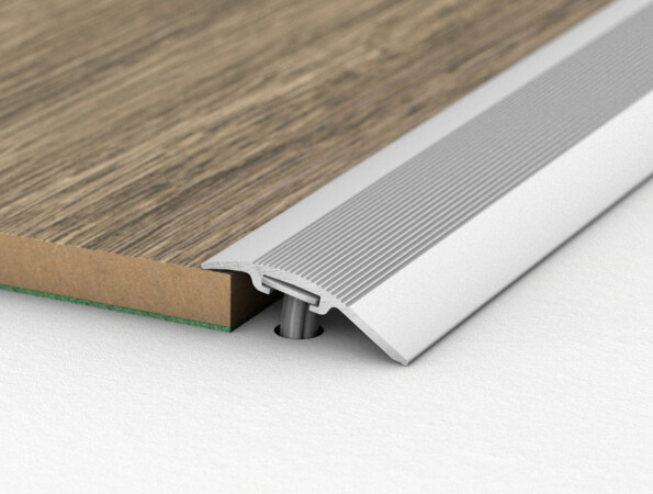 Laminate flooring transition piece connecting two surfaces, showcasing installation detail.