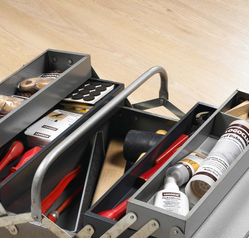 A toolbox laying on laminate flooring from logoclic