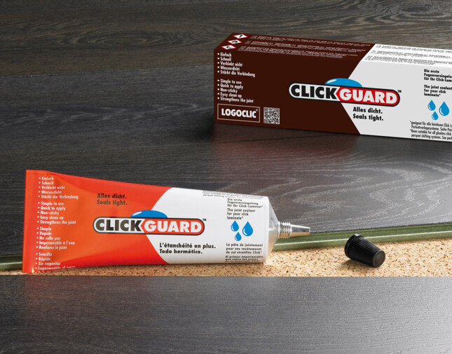 Eine Tube ClickGuard auf Laminatboden.