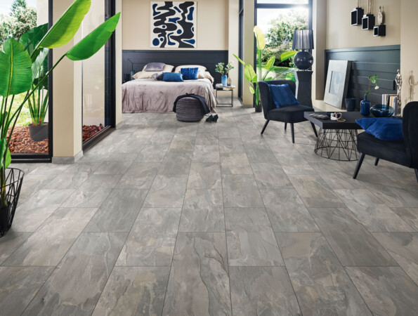 Bedroom with grey laminate flooring from the series 'Elementpro', large windows, and stylish decor.
