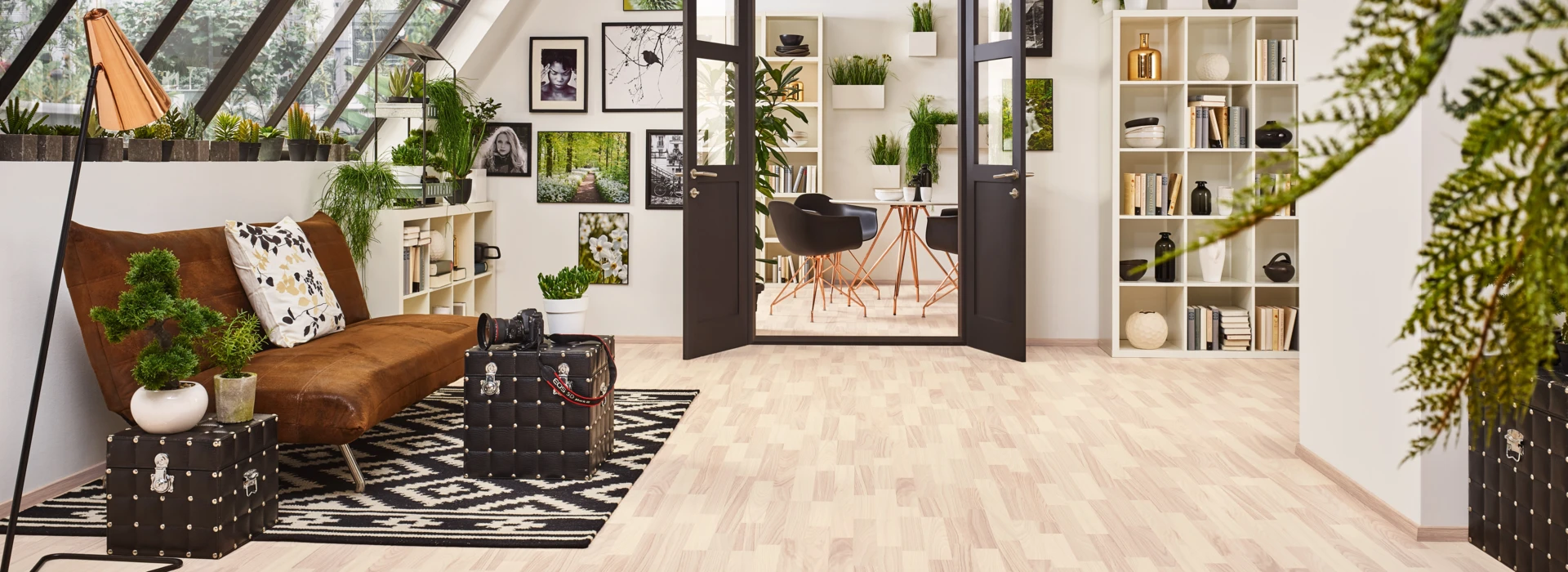 Bright room with stylish laminate flooring, large windows, and modern decor.