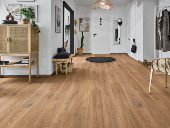 Hallway with natural-look laminate flooring, wicker furniture, and minimalist decor.