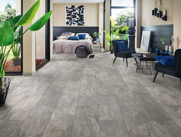 Bedroom with grey laminate flooring from the series 'Elementpro', large windows, and stylish decor.