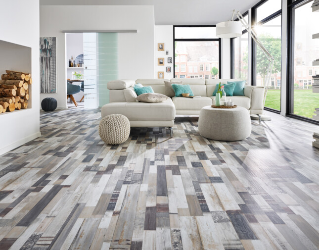 Contemporary living room with stylish laminate flooring, featuring a white sofa, large windows, and a cosy atmosphere.